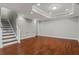 Finished basement area showcasing stairs, wood floors, and recessed lighting at 235 Foxley Way, Roswell, GA 30075