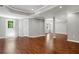 Open basement area with hardwood floors, recessed lighting, and an exterior door at 235 Foxley Way, Roswell, GA 30075