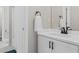 Modern bathroom with white vanity, dark hardware, and a shower with a white curtain at 235 Foxley Way, Roswell, GA 30075