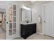 Bathroom with a dark vanity, a framed mirror, and neutral-toned walls for a sophisticated touch at 235 Foxley Way, Roswell, GA 30075