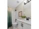 Well-lit bathroom featuring a modern vanity, framed art, and shower with elegant green curtain at 235 Foxley Way, Roswell, GA 30075