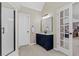 Well lit bathroom featuring a dark vanity with double sinks and a glass enclosed shower stall at 235 Foxley Way, Roswell, GA 30075