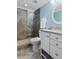 Modern bathroom with a tiled shower, a white vanity, and a round mirror at 235 Foxley Way, Roswell, GA 30075