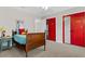 Charming bedroom with a vintage bed and eye-catching red closet doors at 235 Foxley Way, Roswell, GA 30075