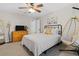 Bright bedroom featuring a simple bed, dresser, and a modern hanging chair at 235 Foxley Way, Roswell, GA 30075