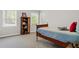 Bright bedroom featuring a simple bed, bookshelf, and natural light from large windows at 235 Foxley Way, Roswell, GA 30075