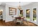 Cozy breakfast nook with hardwood floors, stylish chandelier, and natural light from the windows at 235 Foxley Way, Roswell, GA 30075