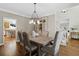 Elegant dining room with hardwood floors and stylish light fixture at 235 Foxley Way, Roswell, GA 30075