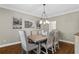Dining room featuring a table with six upholstered chairs and a decorative chandelier at 235 Foxley Way, Roswell, GA 30075