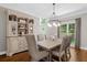 Dining room showcasing a large hutch, chandelier, and dining table with upholstered chairs at 235 Foxley Way, Roswell, GA 30075