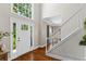 Inviting foyer with hardwood floors, a front door with sidelights and a staircase at 235 Foxley Way, Roswell, GA 30075