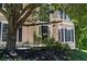 Charming home featuring a black front door, lush landscaping, and inviting curb appeal at 235 Foxley Way, Roswell, GA 30075