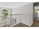 Hallway with white railings and a large window providing natural light to the carpeted stairs at 235 Foxley Way, Roswell, GA 30075