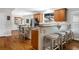 Open kitchen and breakfast bar area featuring hardwood floors, a breakfast bar with stools at 235 Foxley Way, Roswell, GA 30075