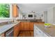 Bright kitchen featuring granite countertops, stainless steel appliances, and seamlessly connects to the living space at 235 Foxley Way, Roswell, GA 30075