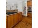 A kitchen with wooden cabinets, granite countertops, stainless steel appliances, and hardwood floors at 235 Foxley Way, Roswell, GA 30075