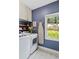 Laundry room featuring modern washer/dryer, storage shelves, and a window with a nature view at 235 Foxley Way, Roswell, GA 30075