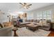Spacious living room with an area rug, ceiling fan, and comfortable furniture at 235 Foxley Way, Roswell, GA 30075