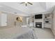 Light and airy bedroom with tray ceilings, fireplace, built-ins, and comfortable seating arrangement at 235 Foxley Way, Roswell, GA 30075