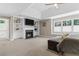 A bright main bedroom has a fireplace, built-in shelves, and large windows that let in plenty of natural light at 235 Foxley Way, Roswell, GA 30075