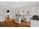 Office space featuring built in bookcases, a corner desk, hardwood floors and glass paneled doors at 235 Foxley Way, Roswell, GA 30075