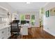 Home office showcasing custom built-ins, hardwood floors and large windows at 235 Foxley Way, Roswell, GA 30075