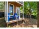 Exterior view of the charming backyard shed with cute chairs on the porch at 235 Foxley Way, Roswell, GA 30075