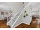 View of the carpeted staircase with decorative hanging plants leading to the home's second story at 235 Foxley Way, Roswell, GA 30075