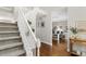A carpeted staircase ascends past a bright home office, complete with wooden floors and ample natural light at 235 Foxley Way, Roswell, GA 30075