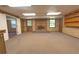 Basement featuring brick fireplace, carpet flooring, and views of outdoors through the windows at 4137 Wellington Hills Ln, Snellville, GA 30039