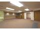 Expansive finished basement with bar, neutral carpet, and a door leading to another room at 4137 Wellington Hills Ln, Snellville, GA 30039