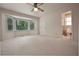 Spacious bedroom featuring a bay window, neutral carpeting, and an en-suite bathroom for added convenience at 4137 Wellington Hills Ln, Snellville, GA 30039