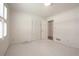 Neutral bedroom featuring a large window with blinds, a built in closet, and carpet at 4137 Wellington Hills Ln, Snellville, GA 30039