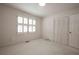 Bedroom featuring neutral carpet, bright window with shutter blinds, and large closet at 4137 Wellington Hills Ln, Snellville, GA 30039