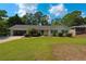 Charming single-story home with a well-manicured lawn and mature landscaping at 4137 Wellington Hills Ln, Snellville, GA 30039