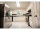 Updated kitchen with stainless steel refrigerator, white cabinetry and granite countertops at 4137 Wellington Hills Ln, Snellville, GA 30039