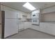 This kitchen features white cabinets and appliances against neutral walls and flooring at 4137 Wellington Hills Ln, Snellville, GA 30039