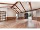 Large living room with hardwood floors, wood-paneled walls, and ample natural light streaming in from the entry way at 4137 Wellington Hills Ln, Snellville, GA 30039