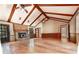 Spacious living room with hardwood floors, exposed beams, a brick fireplace, and a large window at 4137 Wellington Hills Ln, Snellville, GA 30039