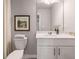 Bright bathroom featuring white cabinetry, a framed mirror, and a decorative painting at 5615 Hislop Ln # 82, Mableton, GA 30126
