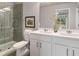 Modern bathroom featuring double vanity, framed mirror and glass-enclosed shower at 5615 Hislop Ln # 82, Mableton, GA 30126