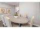 An elegant dining area with rustic wood table, upholstered chairs, and wood-look floors at 5615 Hislop Ln # 82, Mableton, GA 30126
