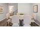 Elegant dining area with rustic table, upholstered chairs, and wood-look floors at 5615 Hislop Ln # 82, Mableton, GA 30126