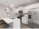 This kitchen features stainless steel appliances, a large island with barstool seating and white cabinets at 5615 Hislop Ln # 82, Mableton, GA 30126