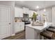 A cozy kitchen with white cabinets, stainless appliances, and island with barstool seating at 5615 Hislop Ln # 82, Mableton, GA 30126