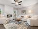 A modern living room with fireplace, light gray walls, two white sofas and a ceiling fan at 5615 Hislop Ln # 82, Mableton, GA 30126