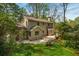 Charming home exterior with a deck, patio, and inviting backyard surrounded by lush greenery at 6795 Brandon Mill Rd, Atlanta, GA 30328