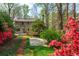 Beautiful backyard featuring a stone pathway leading through lush landscaping at 6795 Brandon Mill Rd, Atlanta, GA 30328