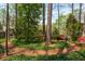 Picturesque backyard featuring mature trees and colorful landscaping at 6795 Brandon Mill Rd, Atlanta, GA 30328