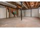 Unfinished basement with concrete floor and exposed beams showing renovation potential at 6795 Brandon Mill Rd, Atlanta, GA 30328